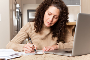 Woman paying bills_ScanStockPhoto_image_1087021_Suprijono Suharjoto.jpg